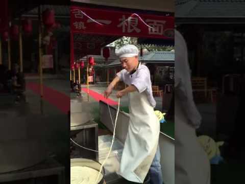 Making of and dancing with one long strand of noodle.