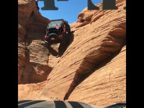 4 wheeled vehicle drives up canyon wall