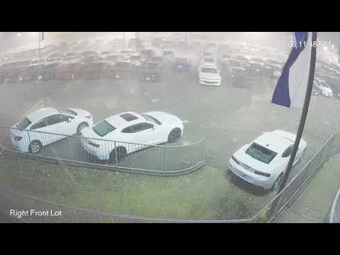 Surveillance video of baseball-sized hail damaging new vehicles in Cullman, Alabama